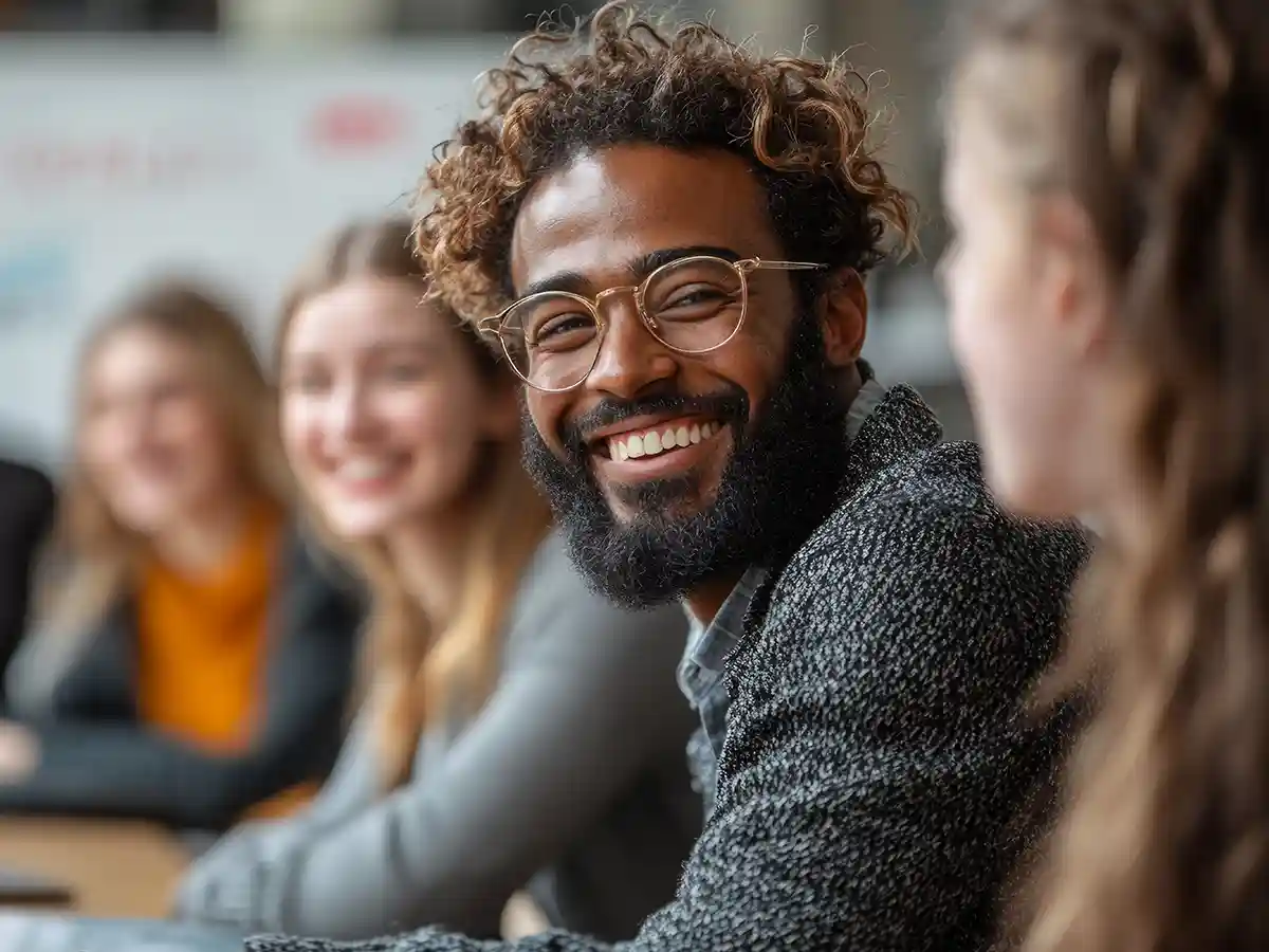 A smiling young man at a table